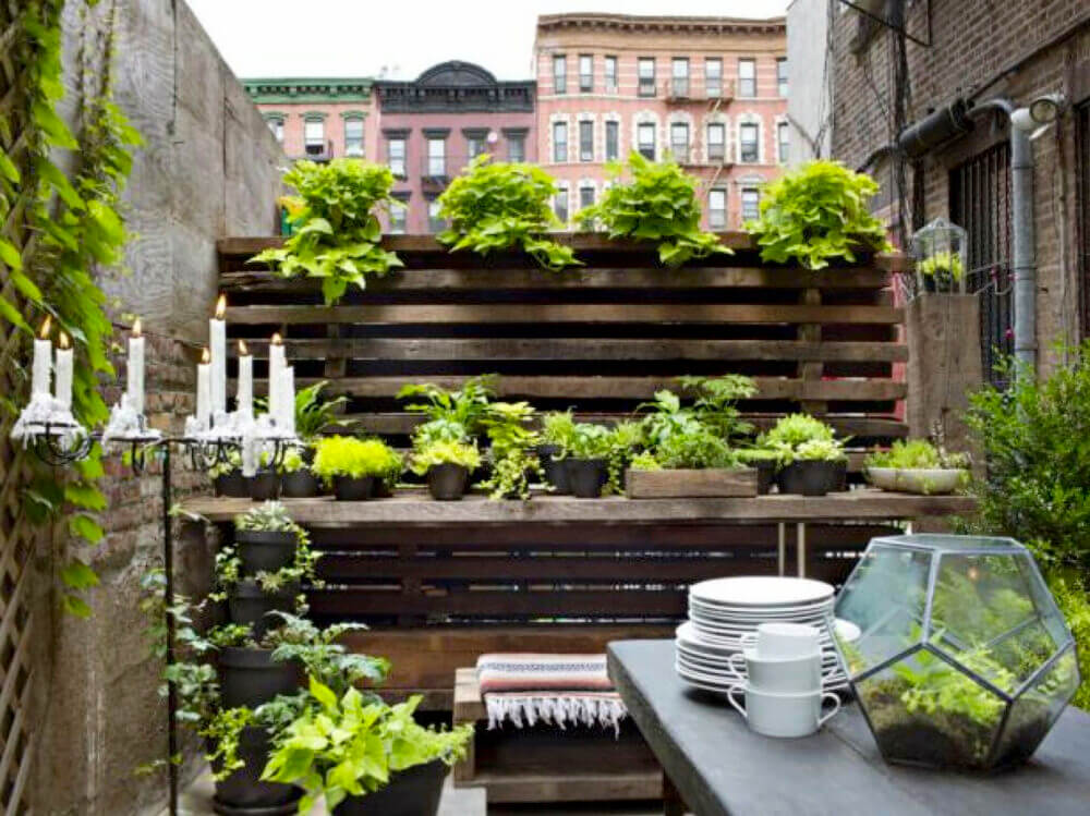 Urban patio with food on table and warehouse architecture in the background